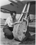 822px-Wooden_wheels_are_attached_to_a_P-51___Mustang___fighter_plane_so_it_may_be_moved_around...jpg